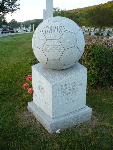 The Davis grave in Hope Cemetery located in Barre, Vermont, contains the body of a young man believed to be a soccer enthusiast. The monument includes the names of his parents. The material of the marker is Barre gray granite.