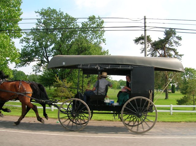 Amish canoe on buggy along Highway US 30 in Wayne County Ohio north of Holmes County Ohio.