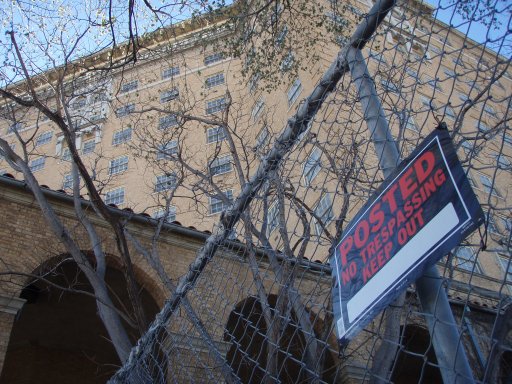 A posted sign warns visitors away from entering the Baker Hotel.