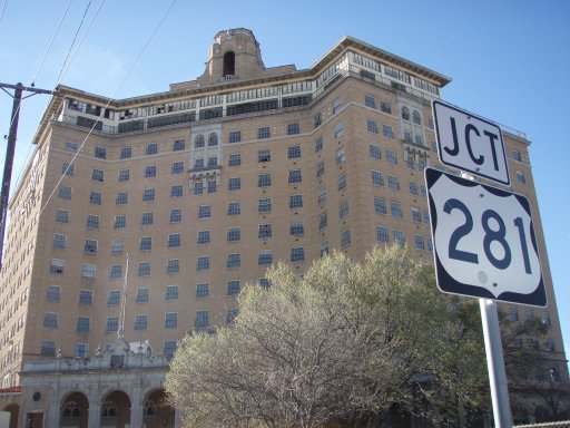 Junction of of US 281 sign stands to the east of the Baker Hotel.