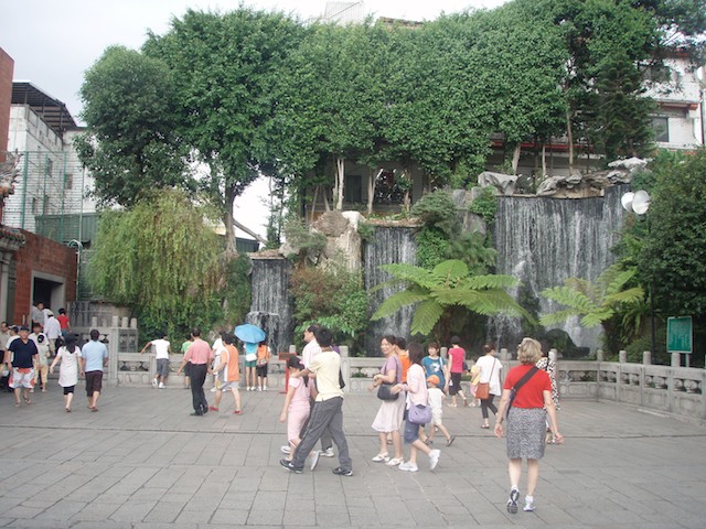 A fountain is cool and refreshing inside the temple gate at Lungshan Temple. The religion mixes the beliefs and practices of Buddhism, Taoism and native ancestor worship.