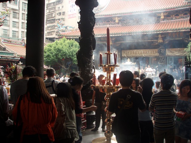 Lungshan Temple in Taiwan is busy each day with thousands of worshippers. Weekends generate the most traffic.