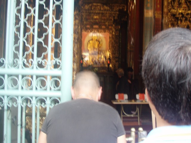 Worshippers kneel before an idol.