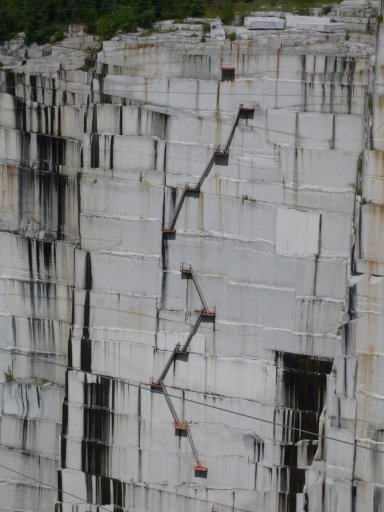 Emergency exit ladders on the granite walls allow stone workers to climb out of the quarry should power fail on the derricks. These ladders are currently not completely connected because cutting is at the top of quarry.