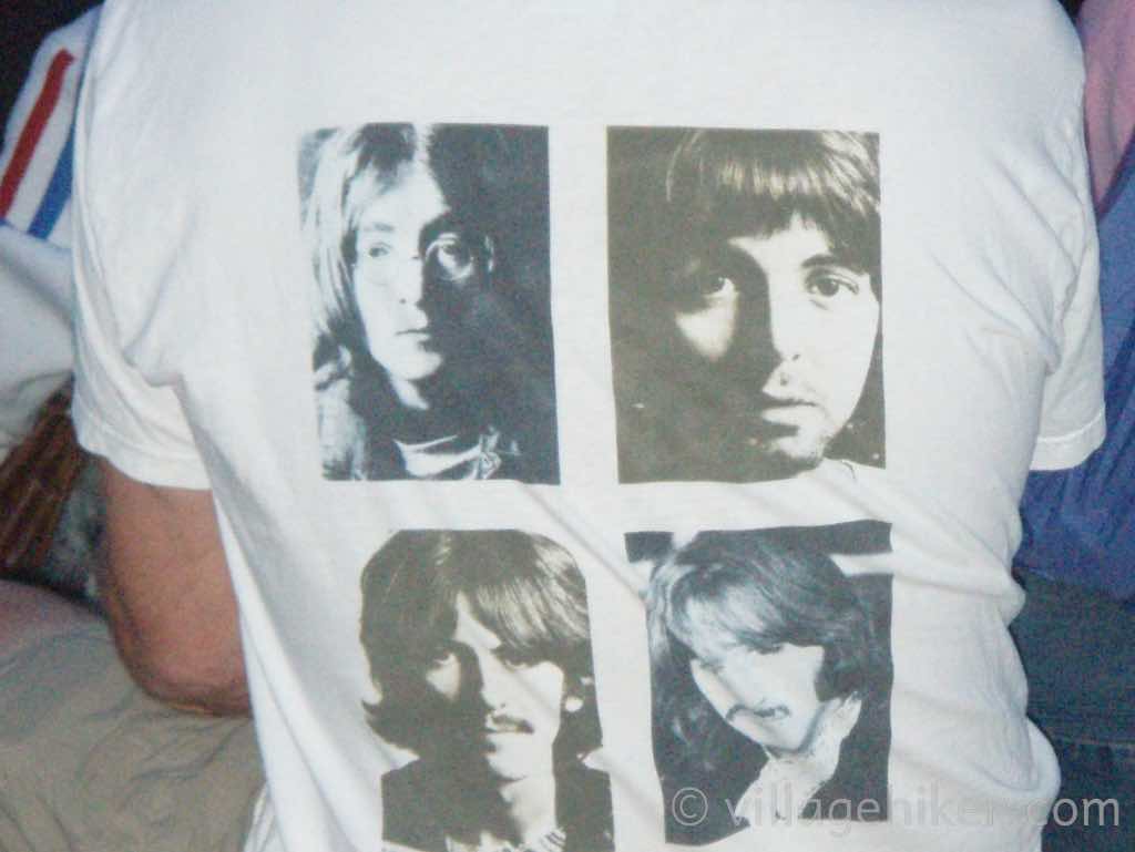 A fan wears a Beatles T Shirt with mug shorts of the Fab Four.