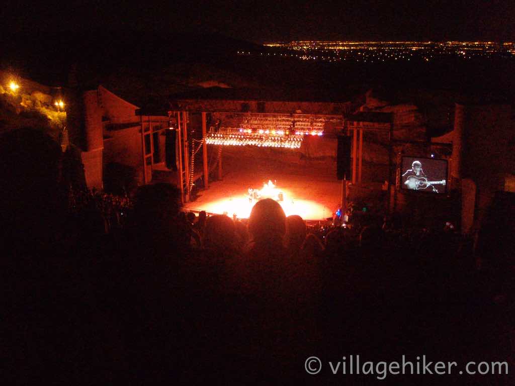 Lighted stage after dark with Denver in the background.