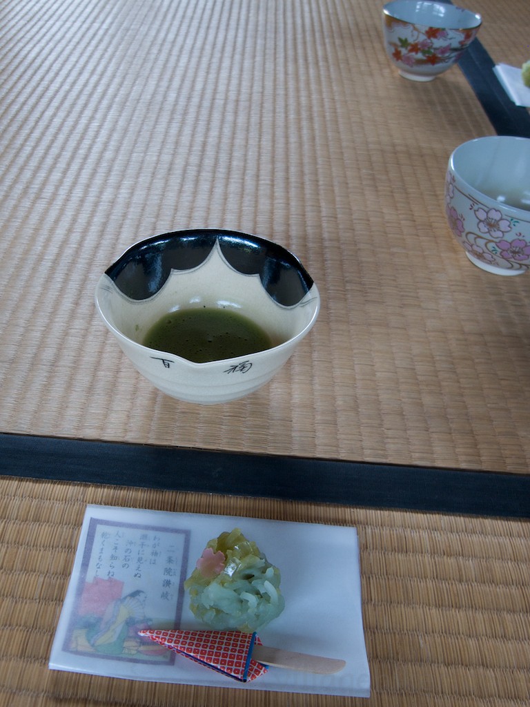 The wagashi sits on your tatami mat. The tea is on the mat adjacent to you. After you finish drinking the tea, you place your empty cup on your mat.