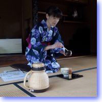 Woman mixes tea in traditional style