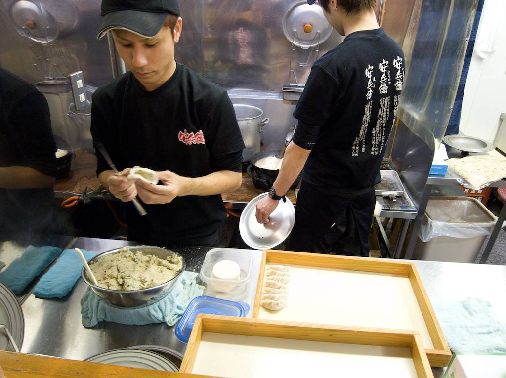Chef prepares Gyoza at Hirome Market Kochi Japan