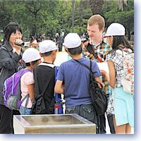 Japanese students chat with an American at Hiroshima Peace Park.