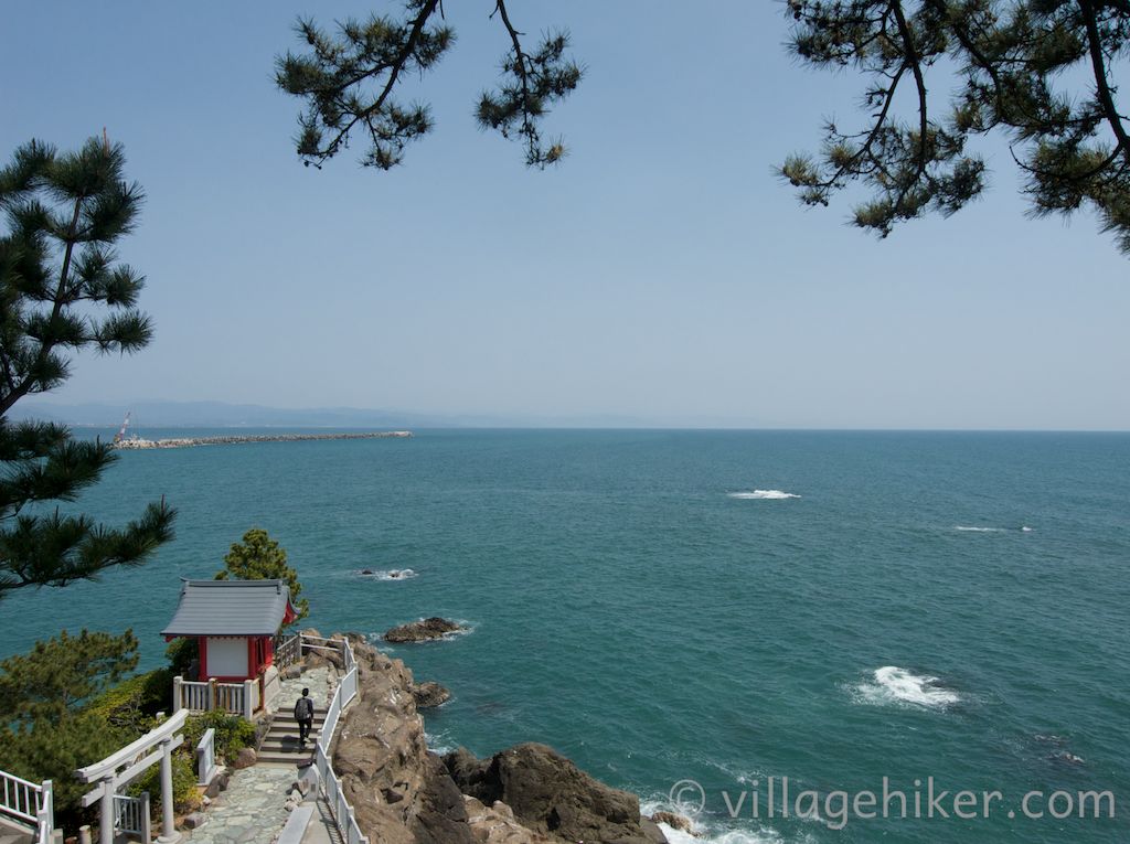 A man approaches Watatsumi Shrine near the edge of Ryūō Point. Other shrines in Japan also honor the spirit of the sea.