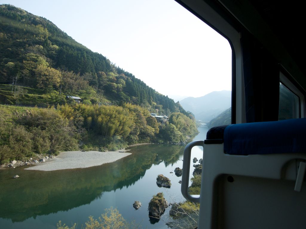 Shikoku countryside from train photos. Prepare to witness steep green hillsides and plunging rivers as you train through Shikoku en route to Kochi. Shikoku island is largely undeveloped. 