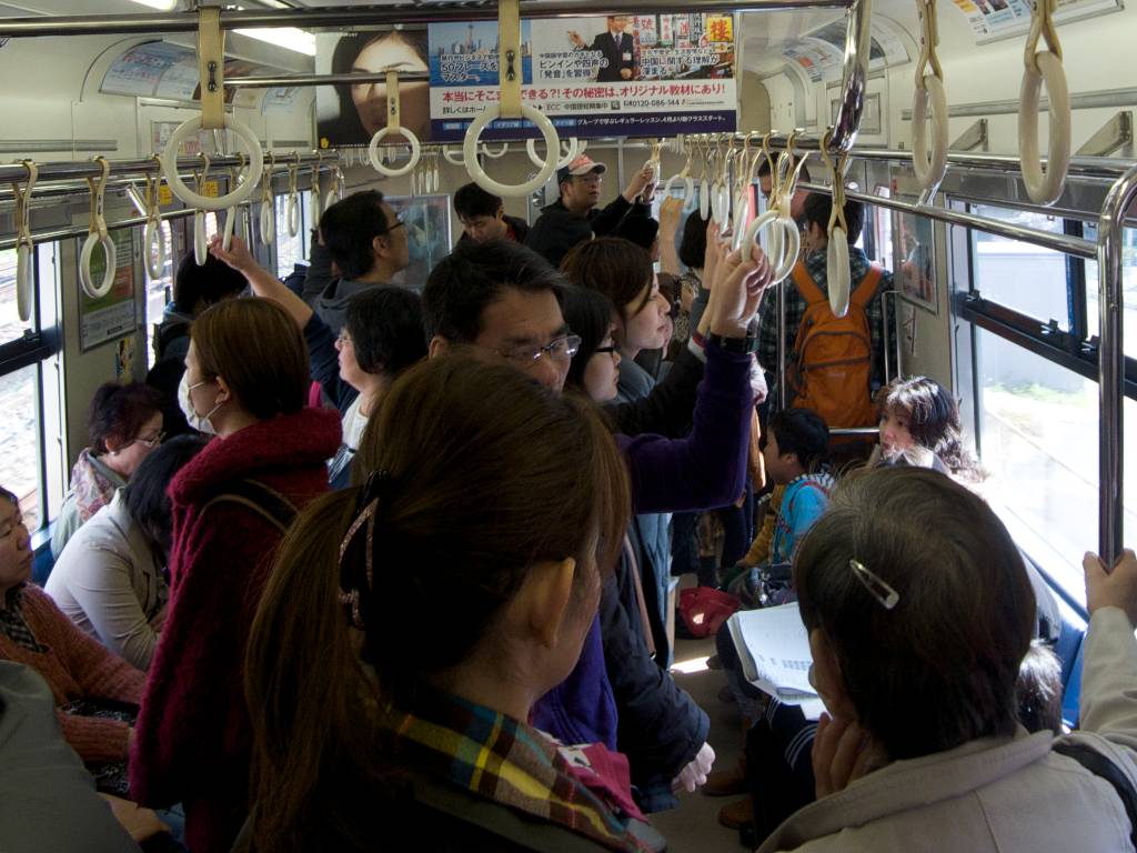 Passengers On Japanese Trains Use Overhead Handholds