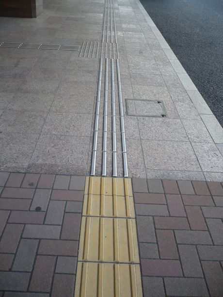 While typically yellow, tactile tile colors can change for aesthetic reasons, while still providing contrast for the visually impaired in Japan