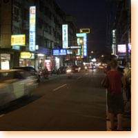 People and vehicles at a night market in Taichung