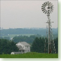 Wind-powered water pump on top of hill.