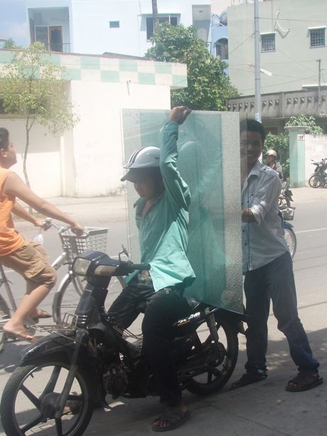 Hauling glass on a motorbike in Ho Chi Minh City Vietnam