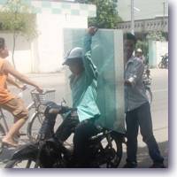 hauling sheet glass on motorbike icon