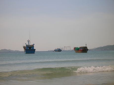 Small Fishing Boats and Modern Shipyard Share Vietnam Coastal Waters